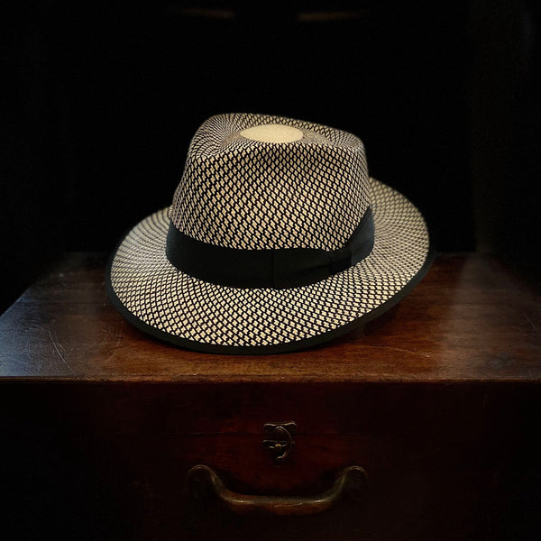 Black and white patterned short brim Panama hat with black grosgrain bow headband
