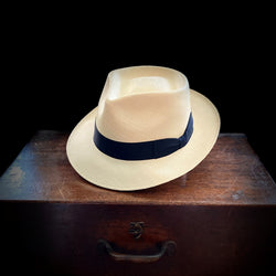 semi bleached straw, 6cm brim Panama hat with an exaggerated pinched crown black grosgrain headband