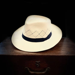 Off white straw open weave super fino Panama hat with navy blue bow grosgrain headband
