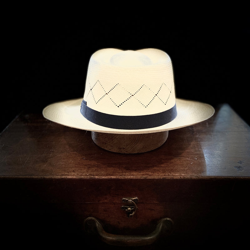 Off white straw open weave super fino Panama hat with navy blue bow grosgrain headband