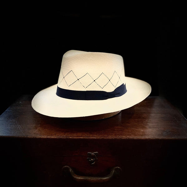 Off white straw open weave super fino Panama hat with navy blue bow grosgrain headband